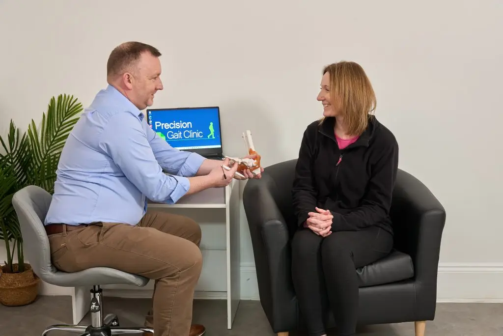 Podiatrist consulting with a patient at the start of a Precision Gait Clinic assessment in Bramhall