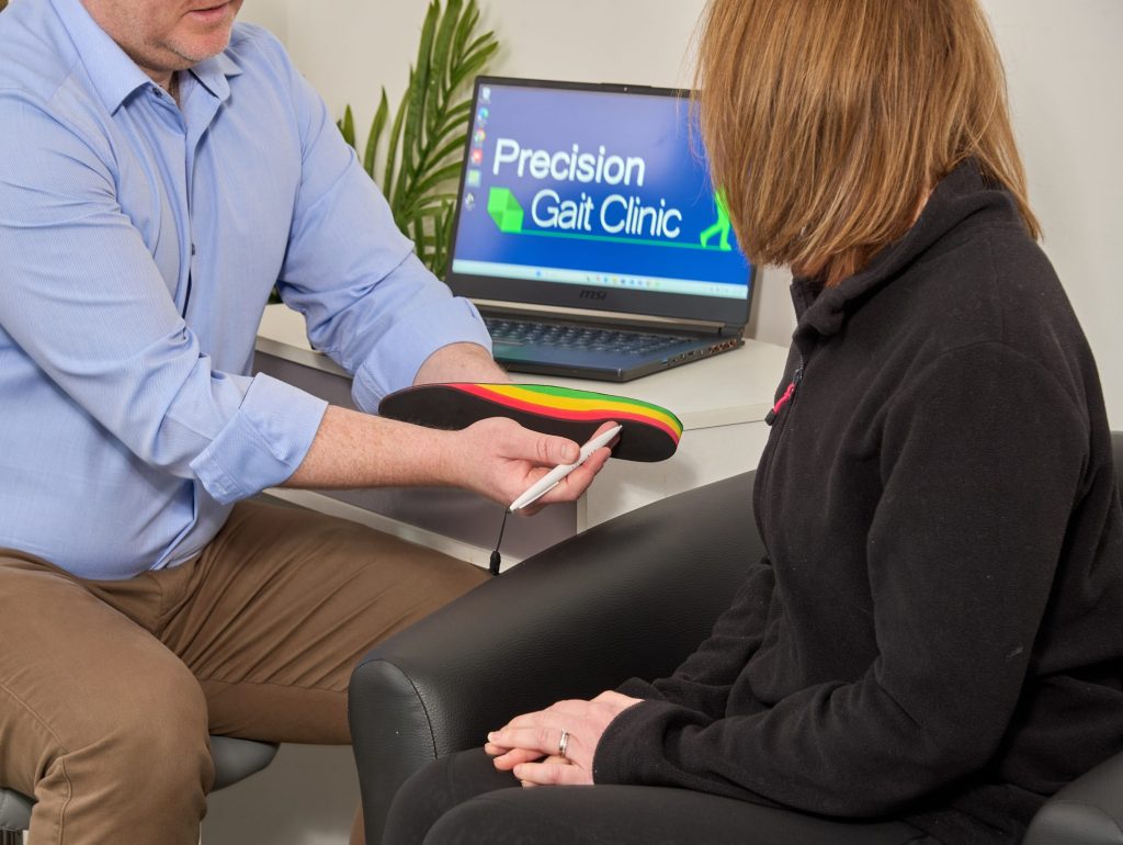 Specialist explaining personalised treatment recommendations during a foot and ankle assessment.